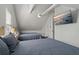 Upstairs bedroom with two twin beds and mounted TV at 394 Ulelah Ave, Palm Harbor, FL 34683