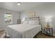 Main bedroom with a queen-size bed and nightstand at 394 Ulelah Ave, Palm Harbor, FL 34683