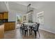 Bright dining room featuring a farmhouse table and six chairs at 394 Ulelah Ave, Palm Harbor, FL 34683