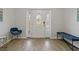 Entryway with a white door, blue chair, and bench at 394 Ulelah Ave, Palm Harbor, FL 34683