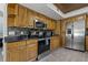Modern kitchen with stainless steel appliances and wood cabinets at 394 Ulelah Ave, Palm Harbor, FL 34683