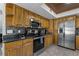 Modern kitchen featuring stainless steel appliances and wood cabinets at 394 Ulelah Ave, Palm Harbor, FL 34683