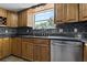 Kitchen with stainless steel dishwasher and granite countertops at 394 Ulelah Ave, Palm Harbor, FL 34683
