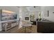 Cozy living room featuring a fireplace, large TV and comfortable seating at 394 Ulelah Ave, Palm Harbor, FL 34683