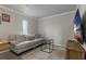 Living room with a gray couch and a large TV at 394 Ulelah Ave, Palm Harbor, FL 34683