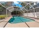 Screened in-ground pool with a spa at 394 Ulelah Ave, Palm Harbor, FL 34683