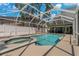 Inviting pool and spa with screened enclosure at 394 Ulelah Ave, Palm Harbor, FL 34683