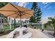 Outdoor grilling area with picnic tables and umbrellas at 4580 Overlook Ne Dr # 297, St Petersburg, FL 33703