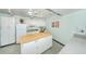 Well-equipped community kitchen with an island and ample counter space at 4580 Overlook Ne Dr # 297, St Petersburg, FL 33703