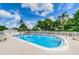 Refreshing community pool with lounge chairs and a surrounding fence at 4580 Overlook Ne Dr # 297, St Petersburg, FL 33703