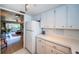 White kitchen with refrigerator and view of living room at 4580 Overlook Ne Dr # 297, St Petersburg, FL 33703