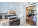 White kitchen with view into living room at 4580 Overlook Ne Dr # 297, St Petersburg, FL 33703