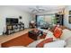 Spacious living area featuring a plush sofa, wood floors, and ample natural light at 4580 Overlook Ne Dr # 297, St Petersburg, FL 33703