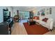 Bright living room with comfy seating, large TV, and sliding doors to balcony at 4580 Overlook Ne Dr # 297, St Petersburg, FL 33703