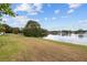 Landscaped backyard with lake view at 12038 Steppingstone Blvd, Tampa, FL 33635