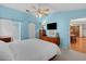 Relaxing bedroom with ceiling fan, dresser, and view into dining area at 12038 Steppingstone Blvd, Tampa, FL 33635