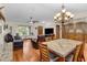 Bright dining room with hardwood floors and a large granite table at 12038 Steppingstone Blvd, Tampa, FL 33635