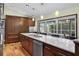 Bright kitchen boasts an island, stainless steel appliances, and pool view at 12038 Steppingstone Blvd, Tampa, FL 33635