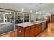 Spacious kitchen featuring island, stainless steel appliances, and view of the pool at 12038 Steppingstone Blvd, Tampa, FL 33635