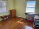 Bedroom showcasing hardwood floors, a wooden dresser, and a desk by the window at 2716 49Th S St, Gulfport, FL 33707