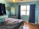 Cozy bedroom featuring hardwood floors, a dresser, a window, and colorful bedding at 2716 49Th S St, Gulfport, FL 33707