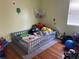Comfortable bedroom with hardwood floors, a gray bed, and decorative wall hangings at 2716 49Th S St, Gulfport, FL 33707
