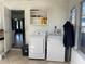 Utility room with side by side washer and dryer with shelf above; tiled flooring at 2716 49Th S St, Gulfport, FL 33707