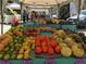 A farmer's market stall is filled with fresh fruit and vegetables and shoppers at 2716 49Th S St, Gulfport, FL 33707