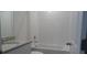 Clean bathroom with bathtub, granite countertop, and tiled walls at 31693 Wild Grape Lane, Brooksville, FL 34602