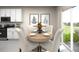 Kitchen dining area with round table and four chairs, overlooking backyard at 31693 Wild Grape Lane, Brooksville, FL 34602
