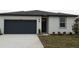 Single-story home with a two-car garage and landscaped lawn at 31693 Wild Grape Lane, Brooksville, FL 34602