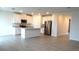 Open concept kitchen with island and stainless steel appliances at 31693 Wild Grape Lane, Brooksville, FL 34602