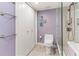 Bathroom with toilet, shower, and decorative wall art at 736 Island Way # 606, Clearwater Beach, FL 33767