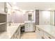 Elegant bathroom with double vanity, marble countertop, and frameless shower at 736 Island Way # 606, Clearwater Beach, FL 33767