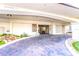 Condominium building entrance with paved driveway and landscaping at 736 Island Way # 606, Clearwater Beach, FL 33767