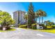 Luxury beachfront condo building with lush landscaping and gated entrance at 736 Island Way # 606, Clearwater Beach, FL 33767