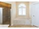 Bathroom with a large soaking tub, shower, and updated fixtures at 924 Bunker View Dr, Apollo Beach, FL 33572