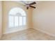 Empty bedroom with ceiling fan and arched window with shutters at 924 Bunker View Dr, Apollo Beach, FL 33572