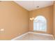 Bright dining room with tile floors, chandelier, and arched window at 924 Bunker View Dr, Apollo Beach, FL 33572