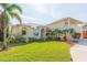 Two-story house with a landscaped lawn, palm trees, and a two-car garage at 924 Bunker View Dr, Apollo Beach, FL 33572