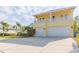 Two-story house with a large driveway, two-car garage, and balcony at 924 Bunker View Dr, Apollo Beach, FL 33572