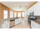 Bright kitchen featuring white cabinets, granite counters, and tile floors at 924 Bunker View Dr, Apollo Beach, FL 33572