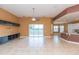 Spacious living room with tile floors, a ceiling fan, and sliding glass doors at 924 Bunker View Dr, Apollo Beach, FL 33572