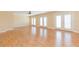 Spacious living room with light laminate wood flooring and access to a balcony at 924 Bunker View Dr, Apollo Beach, FL 33572