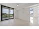 Bedroom with sliding glass doors opening to a balcony and stadium view at 301 1St S St # 205, St Petersburg, FL 33701
