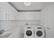 Laundry room with side-by-side washer and dryer, and white cabinetry at 301 1St S St # 205, St Petersburg, FL 33701