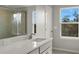 Bathroom with vanity, shower, and large window at 31472 Woodland Race Loop, Wesley Chapel, FL 33545