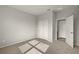 Spacious bedroom with neutral walls, carpet flooring, and a door to a bathroom at 31472 Woodland Race Loop, Wesley Chapel, FL 33545