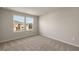 Well-lit bedroom with carpet and two windows at 31472 Woodland Race Loop, Wesley Chapel, FL 33545