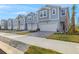 Row of charming townhouses with attached garages and paved driveways at 31472 Woodland Race Loop, Wesley Chapel, FL 33545